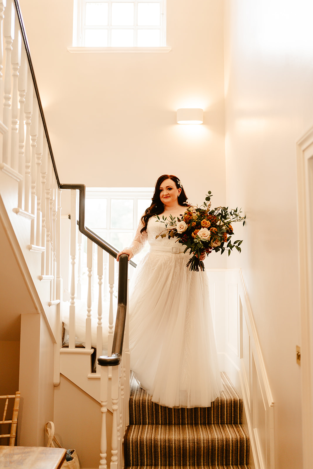 bride walks down the stairs at Ballogie House during a scottish wedding