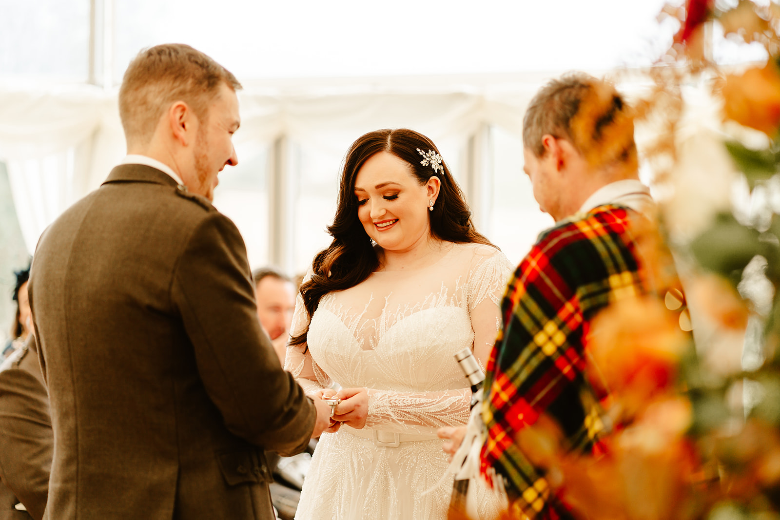 bride put a ring on her groom during their ballogie house wedding ceremony 