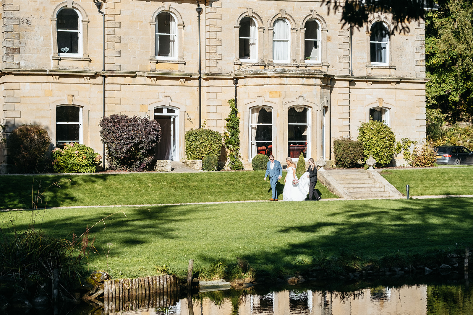 Bride walks in front of Hackness Grange as she prepares to walk down the aisle 