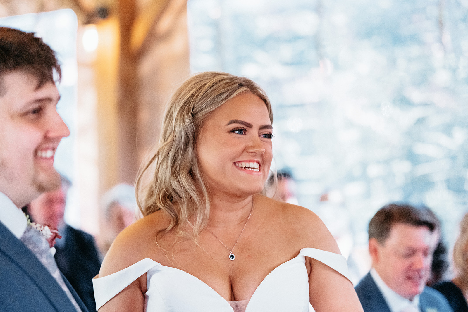 Bride laughs and smiles as she says her vows