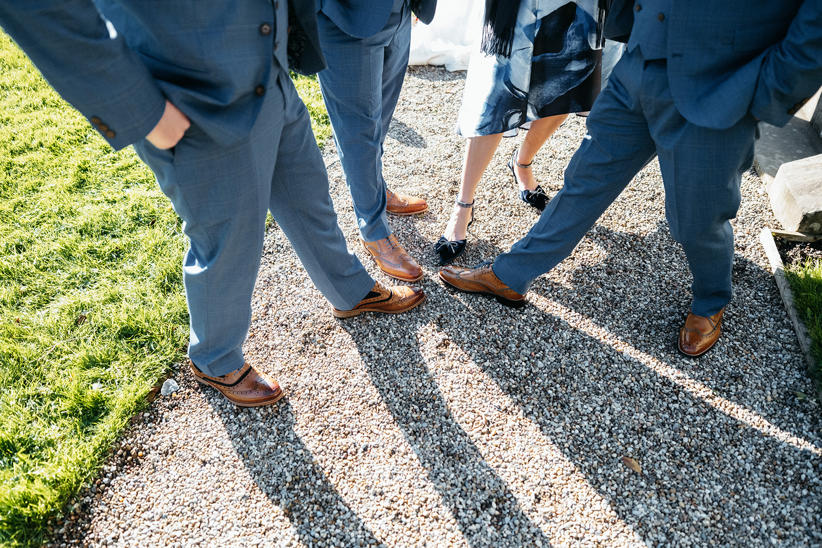 Groomsmen compare shoes after the ceremony.
