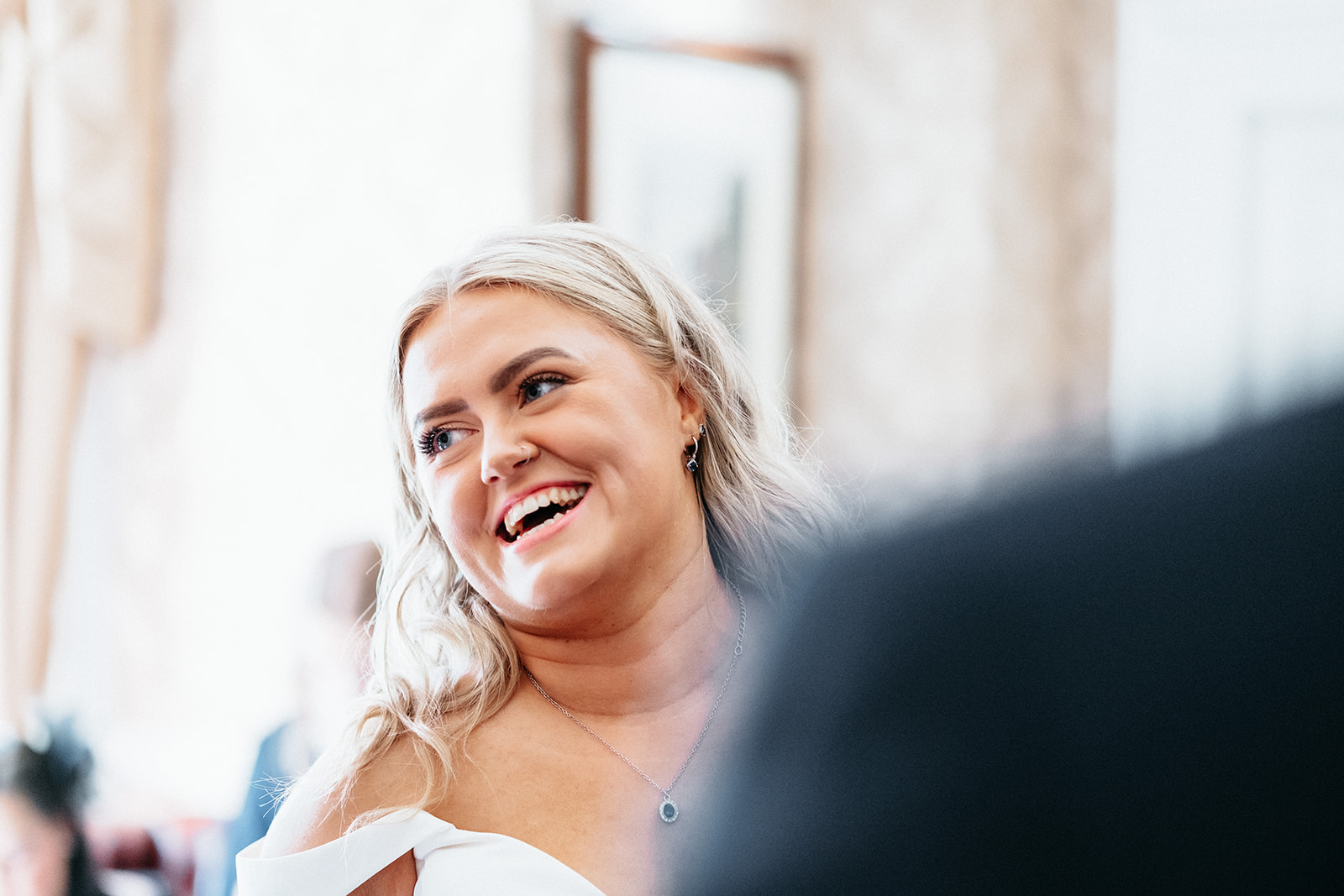 Bride laughs and smiles during welcome drinks