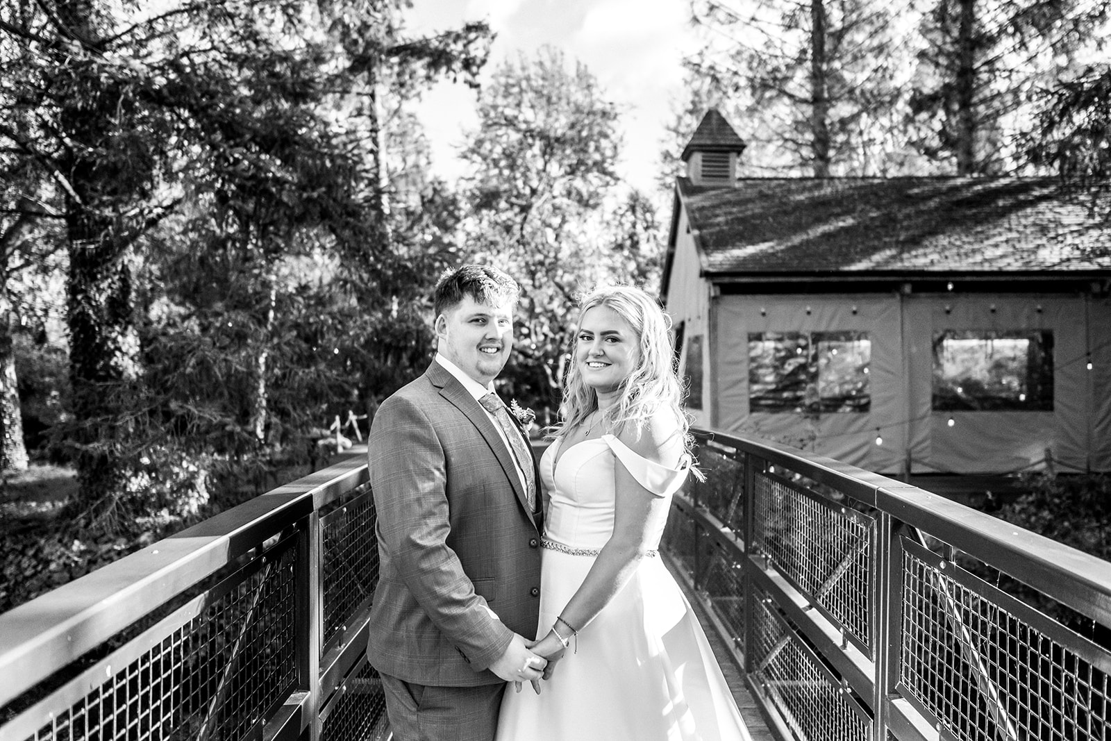 Black and White photo of a bride and groom at Hackness Grange during the autumn standing on the bride to the island. 