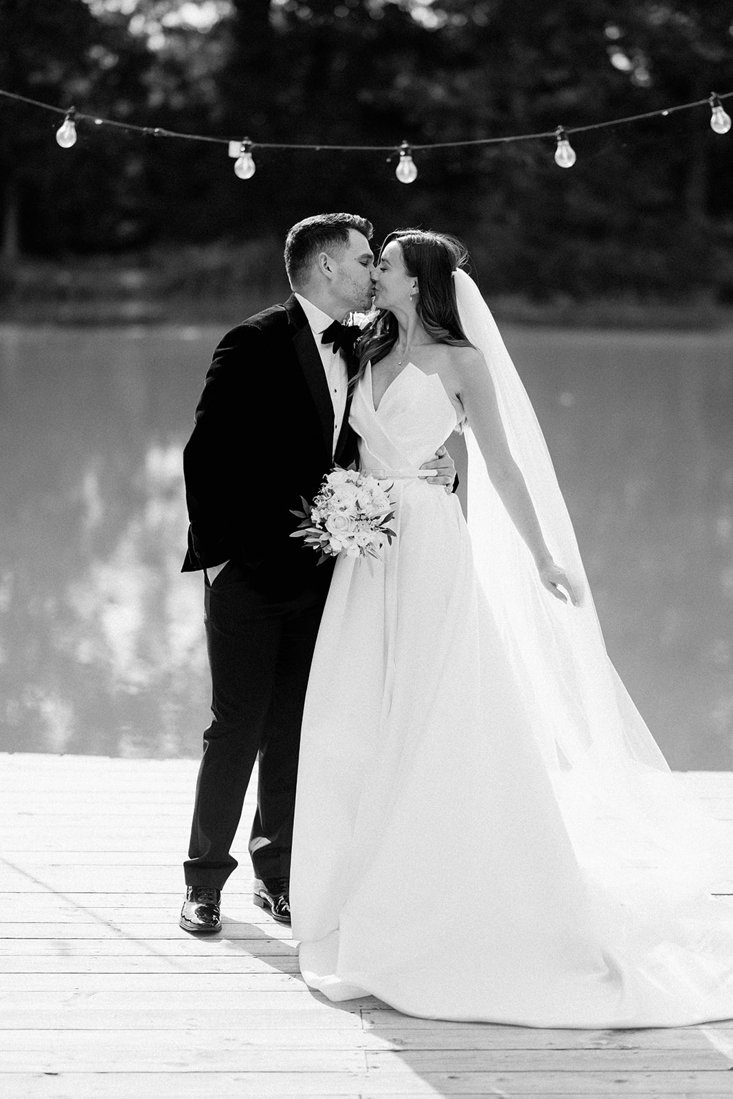 bride and groom in front of lake at barns and yard wedding venue