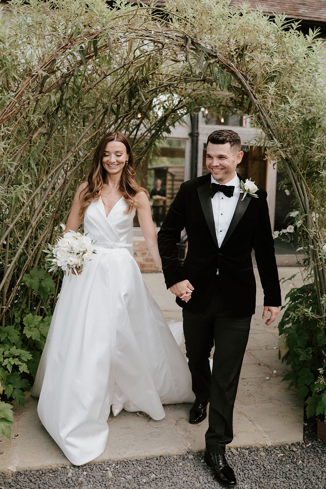 bride and groom walking at barns and yard wedding venue