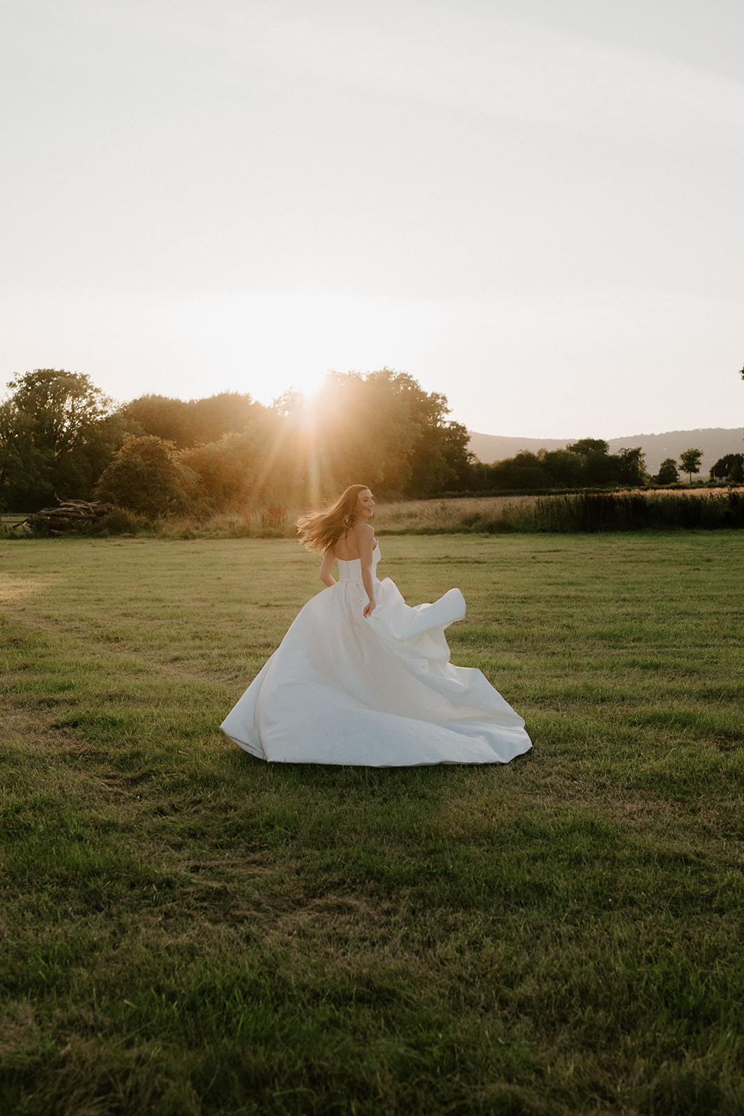 bride running off into sunset at barns and yard 