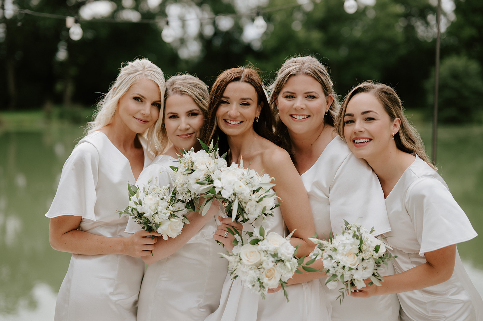 bridesmaids in front of lake at barns and yard wedding venue