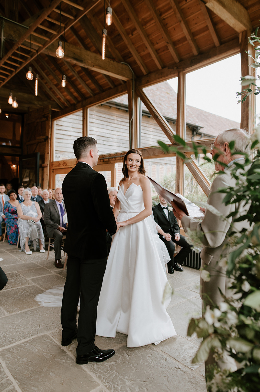 couple getting married exchanging vows at barns and yard wedding venue