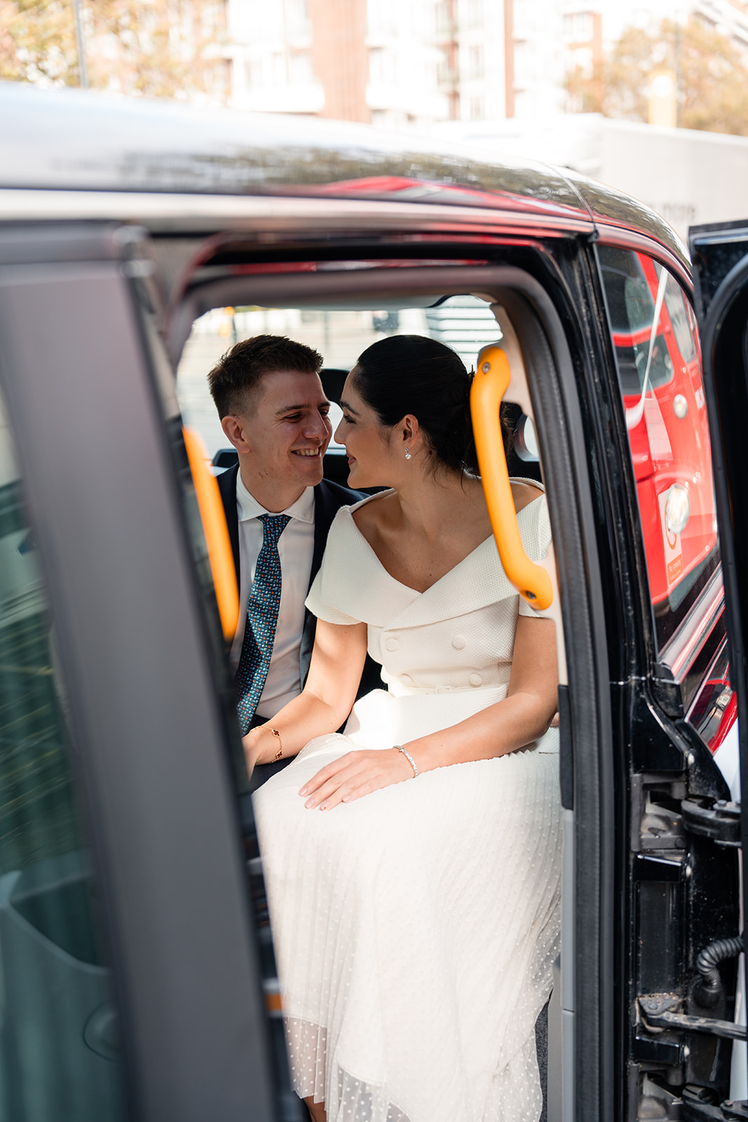 wedding couple arriving at Marylebone old town hall in black cab