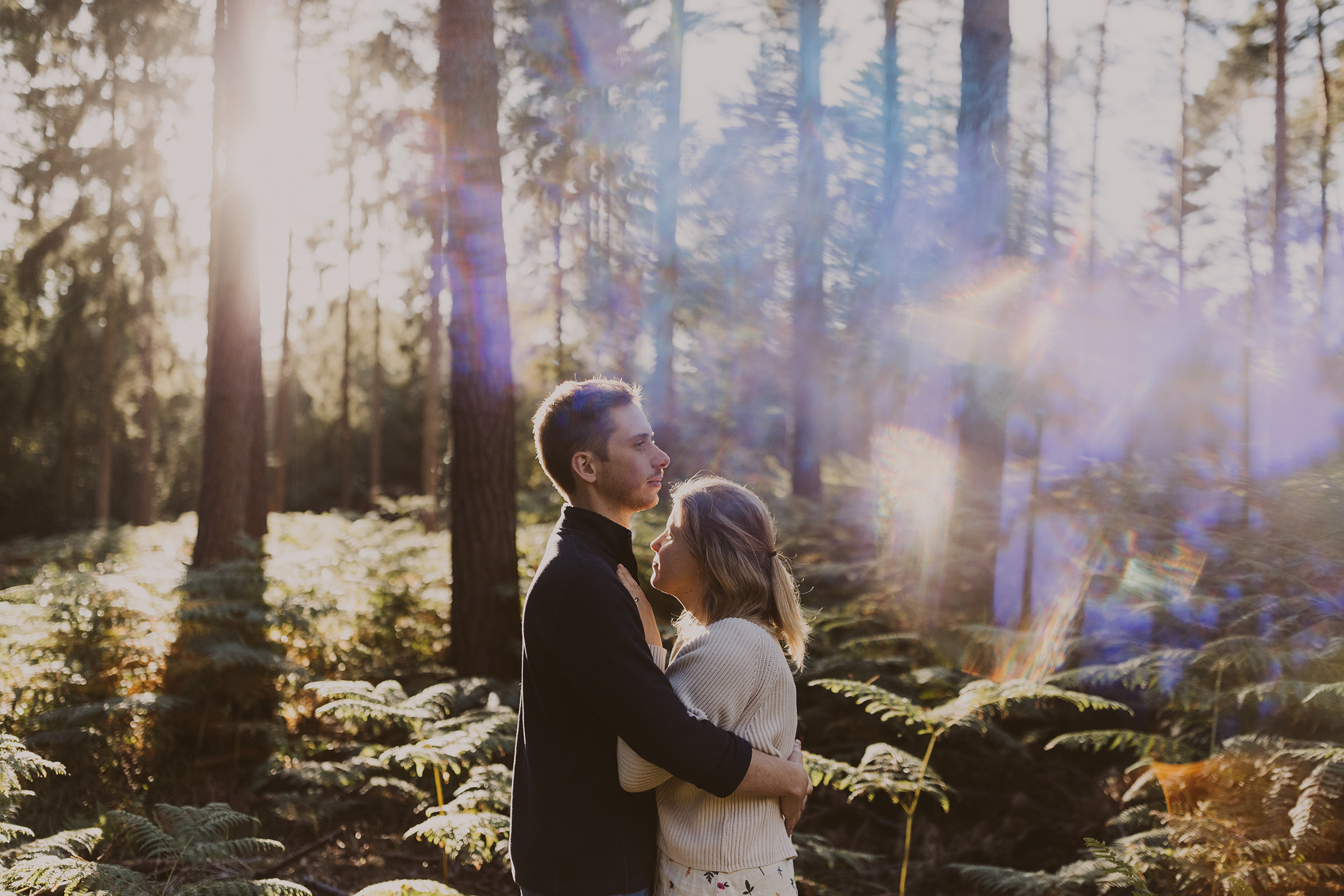 A couple embrace in the woods at Virgina Water, Surrey