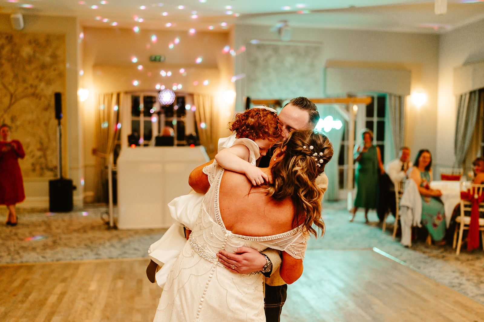 bride and groom dance with their daughter on dancefloor at maryculter house hotel wedding