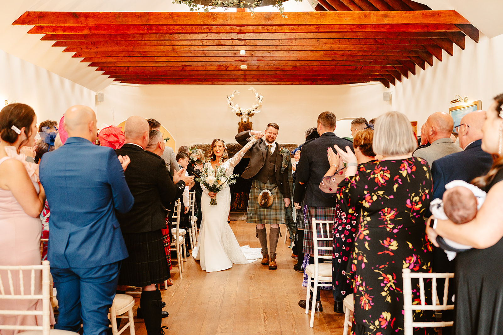 couple walk down the aisle after getting married at Aswanley wedding venue