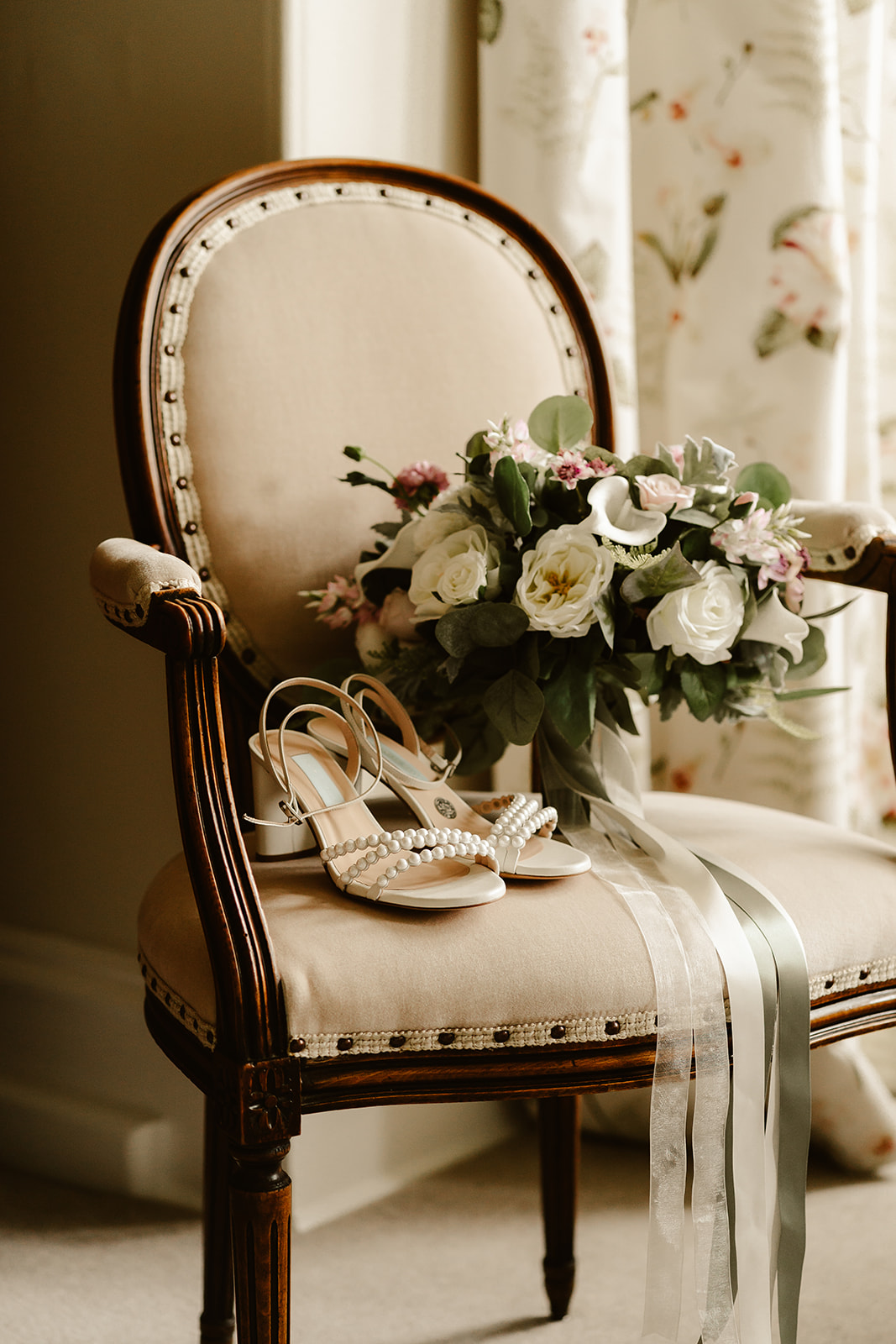 brides flowers and shoes sit on a chair