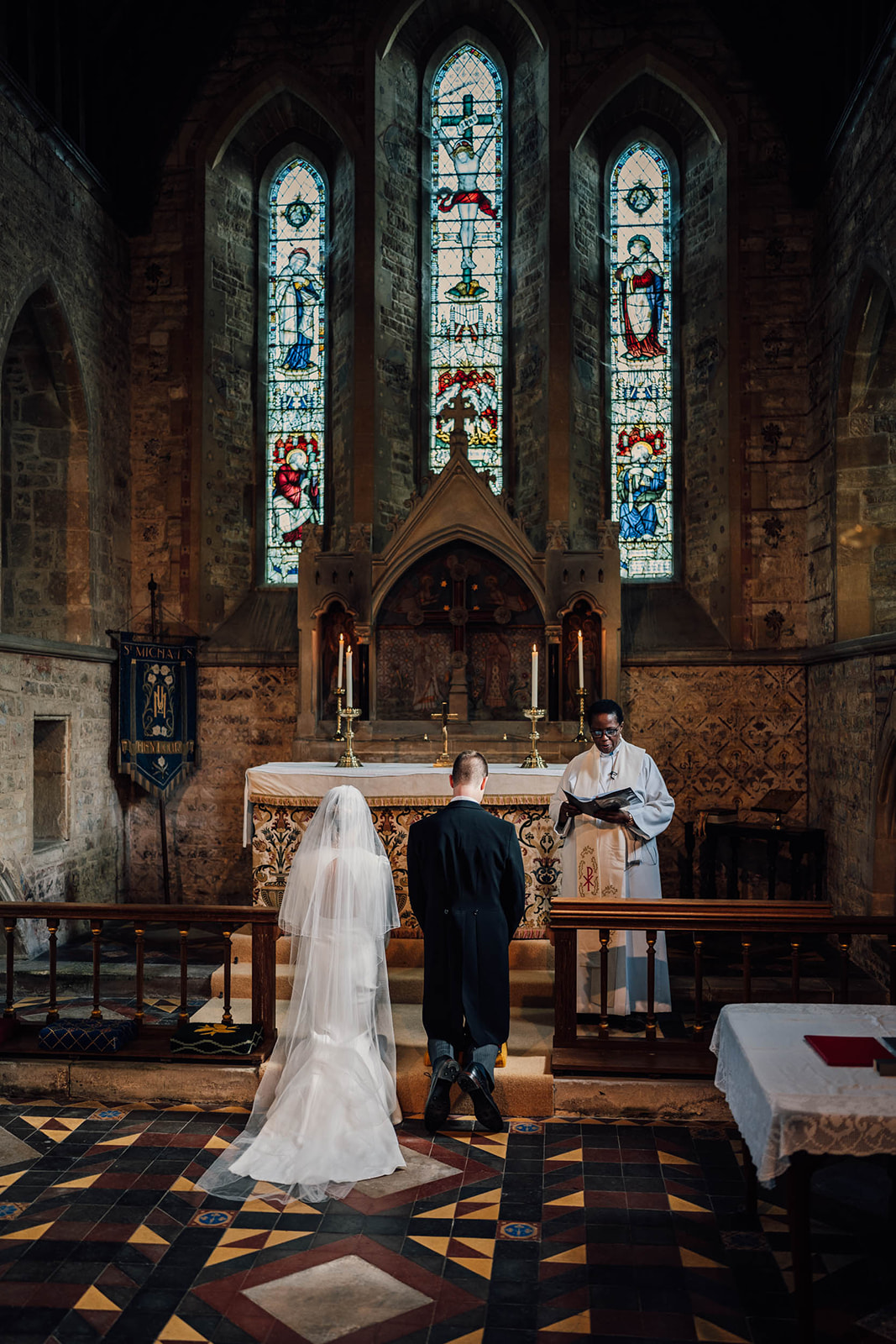 Bride and groom kneeling at Church 