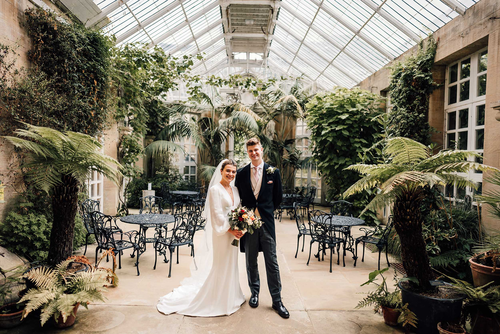 bride and groom in the conservatory at Harlaxton Manor