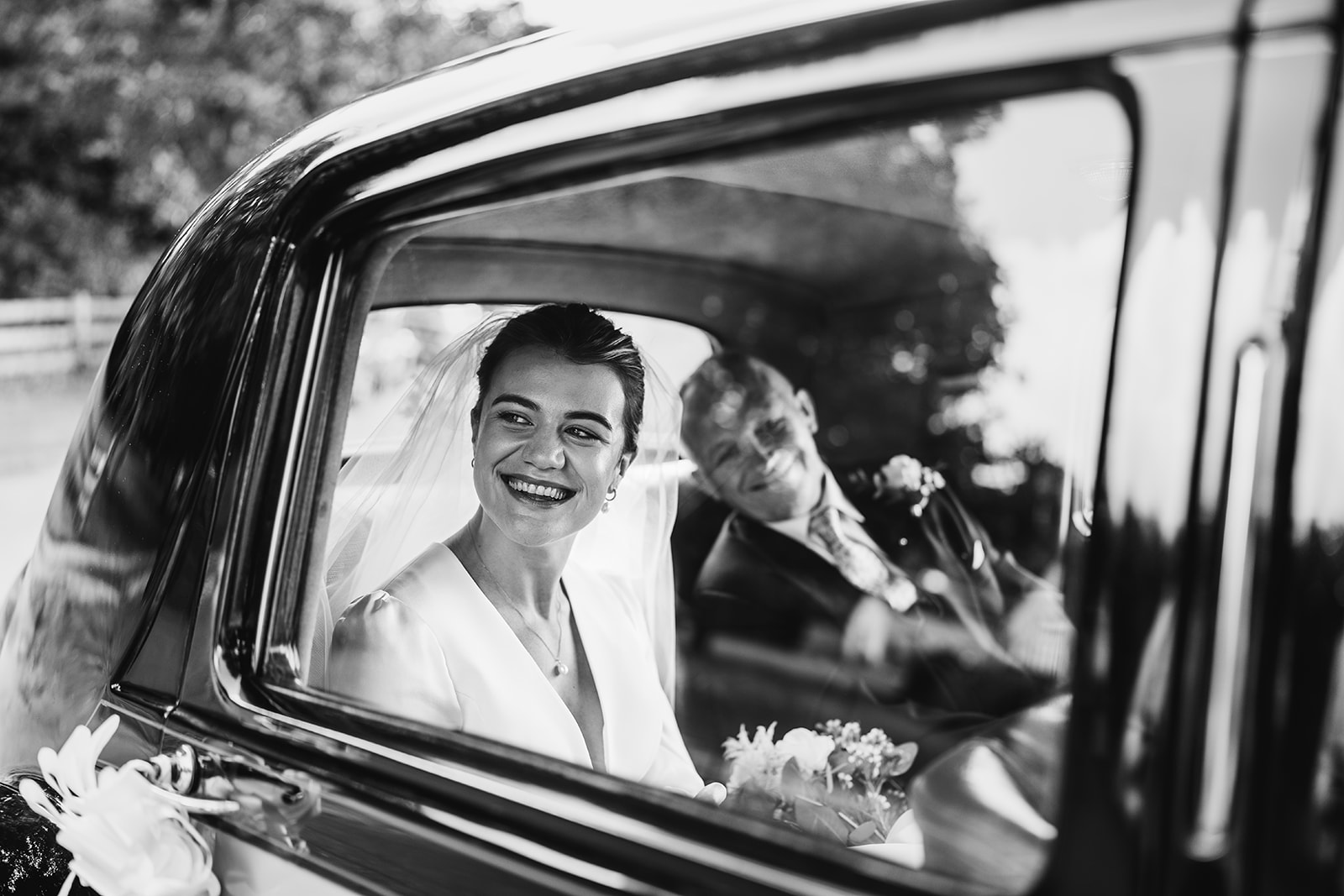 bride arriving at Church in a wedding car with her father