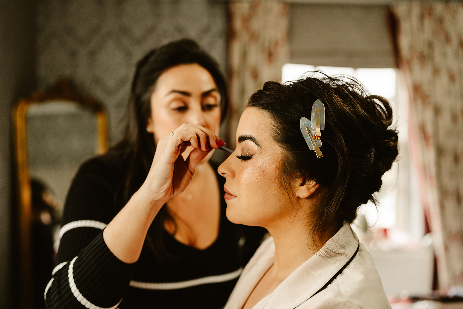 bride is having her make up applied at ballogie house