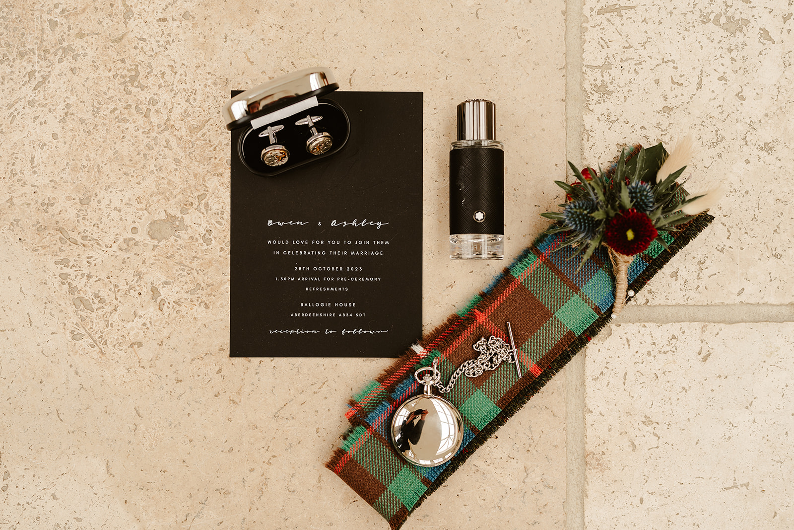 wedding details includes grooms cuff links, rings, pocket watch and tartan fabric