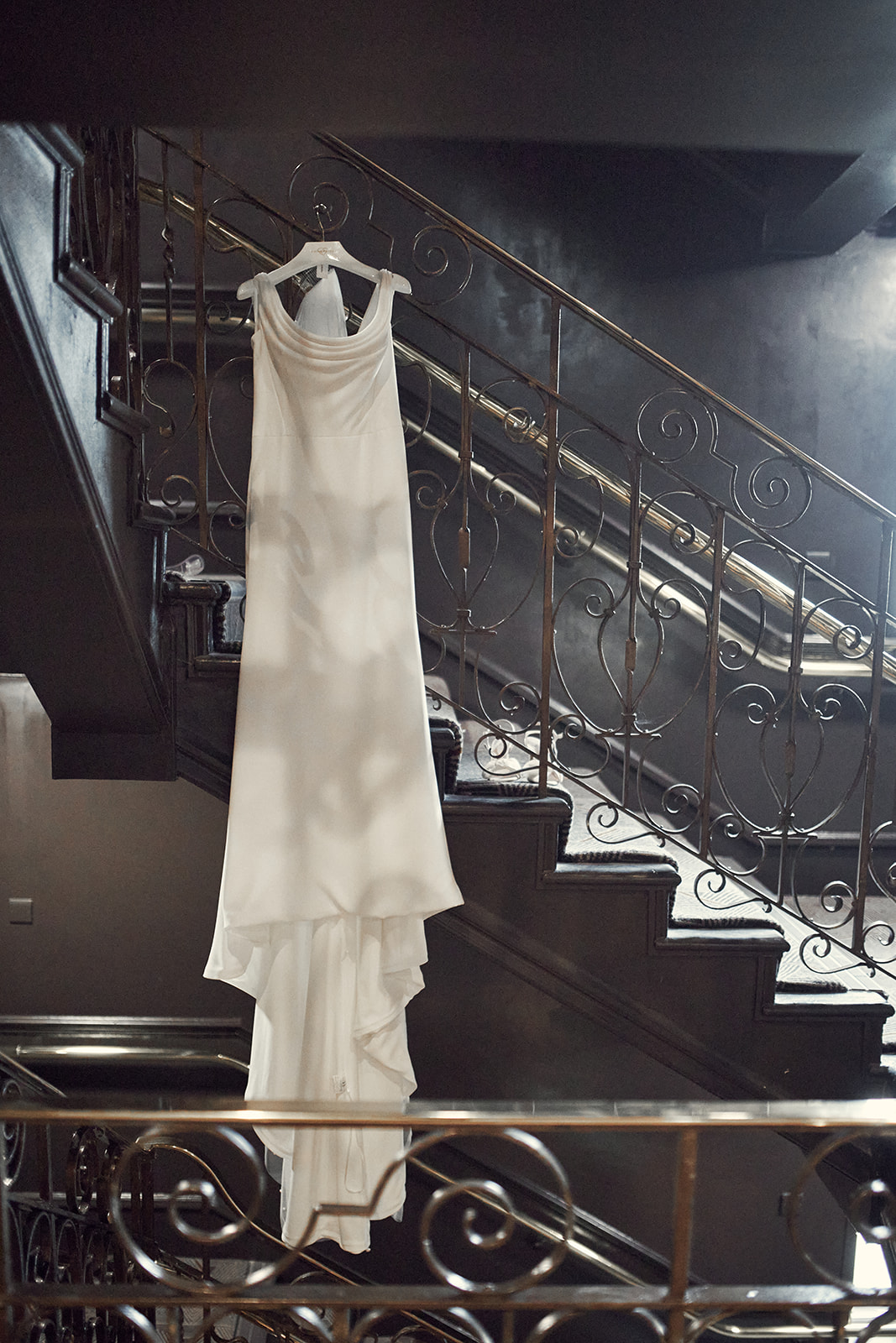 bride's dress hanged on the stairs