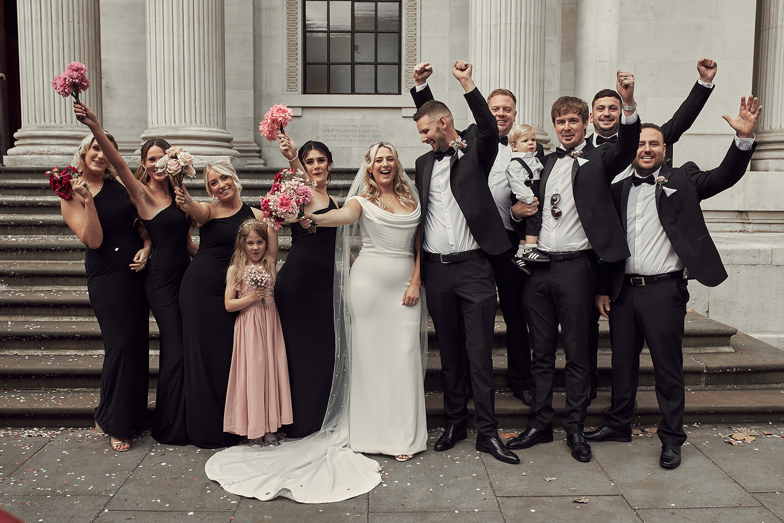portrait of Katy and Max with the wedding entourage at Marylebone Town Hall