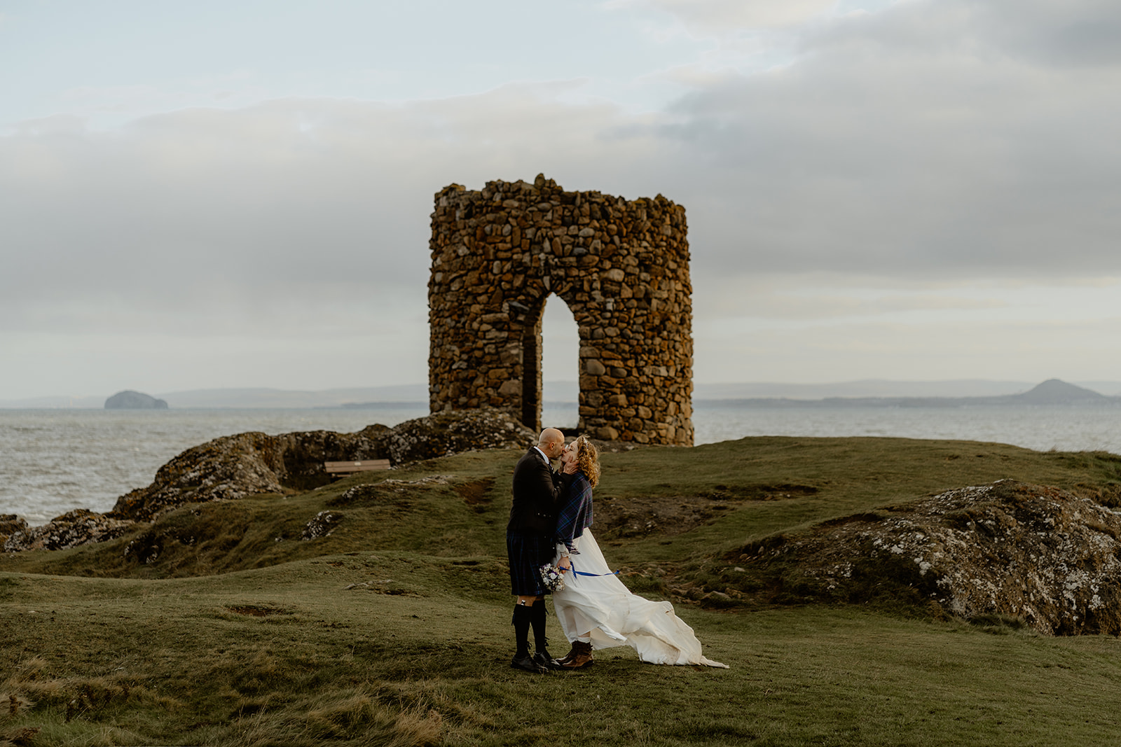 Couple share a kiss in front of Lady's Tower on the Elopement
