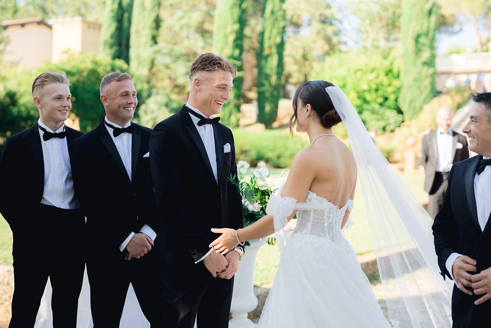 bride and groom smiling and laughing at the beginning of their wedding's ceremony at Villa la Selva