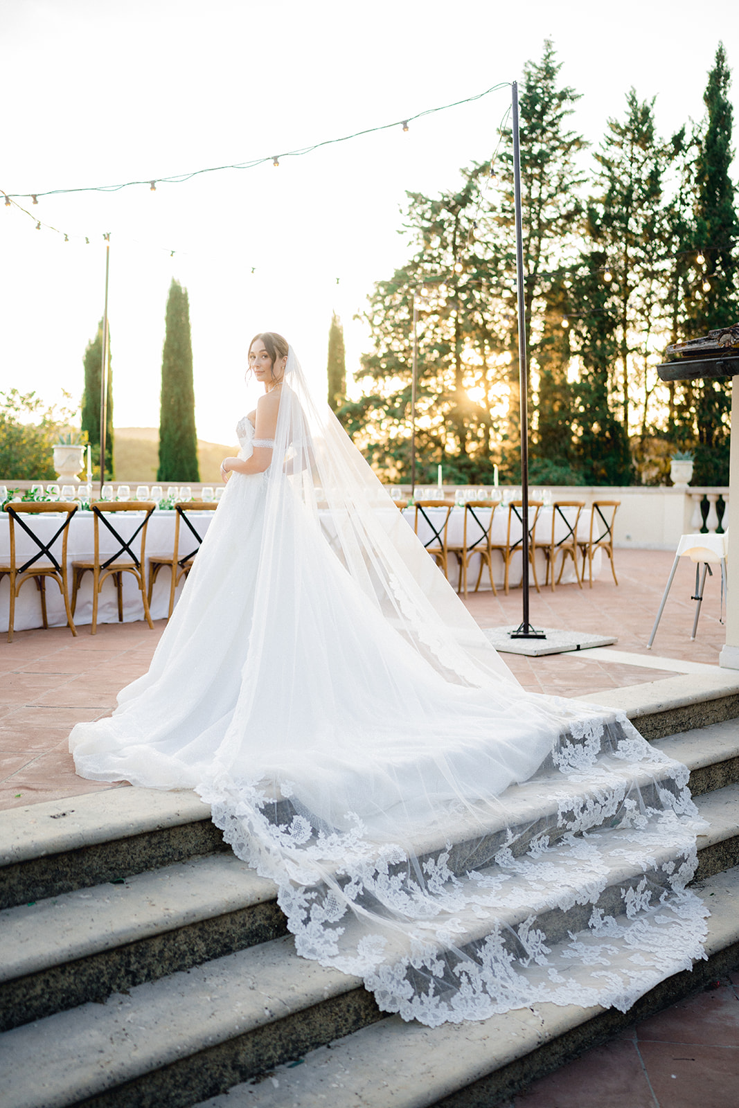 The bride showcasing the back of her Maggie Sottero dress and veil on the terrace of Villa La Selva