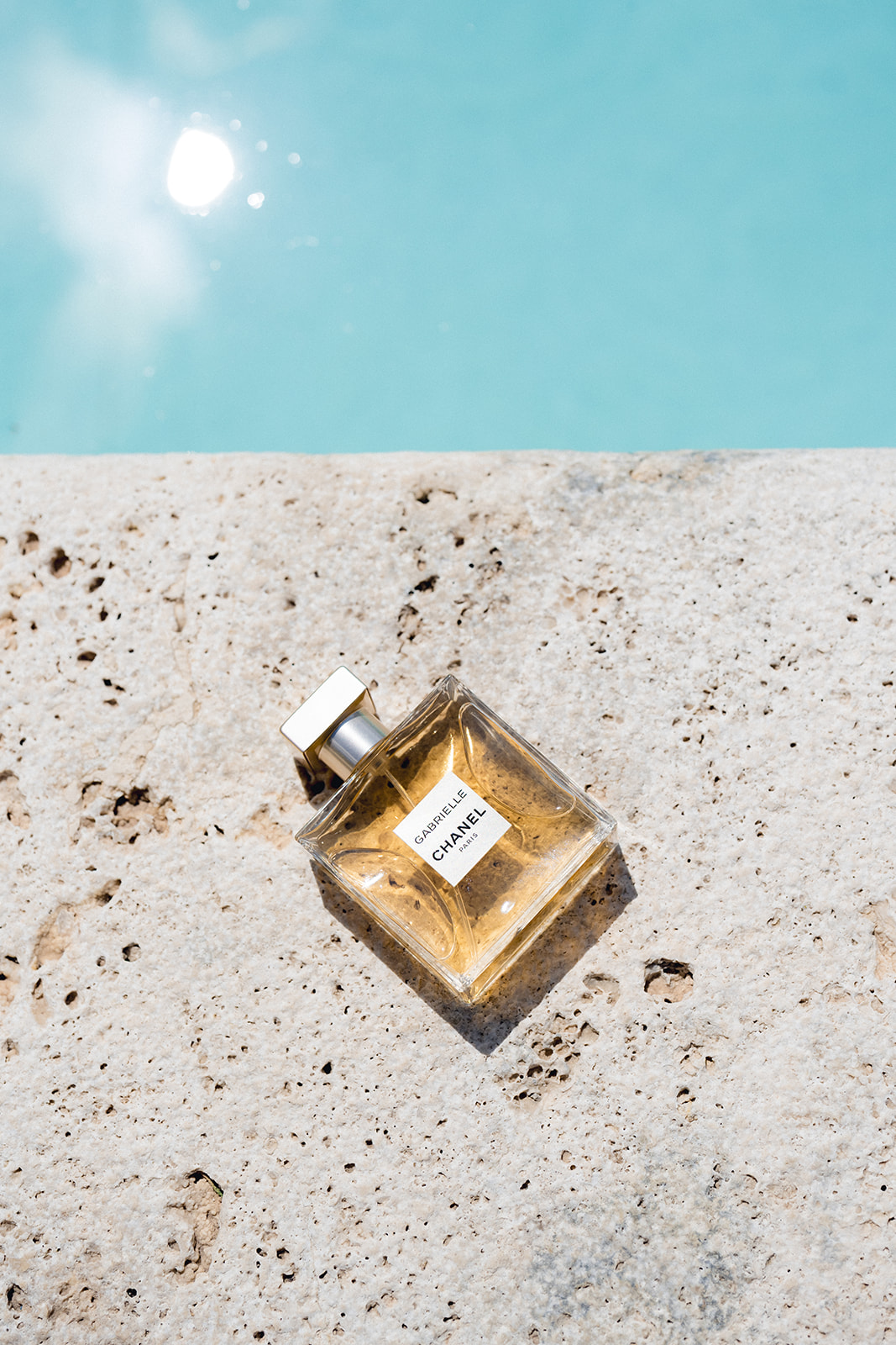 The bride's Chanel perfume by the poolside