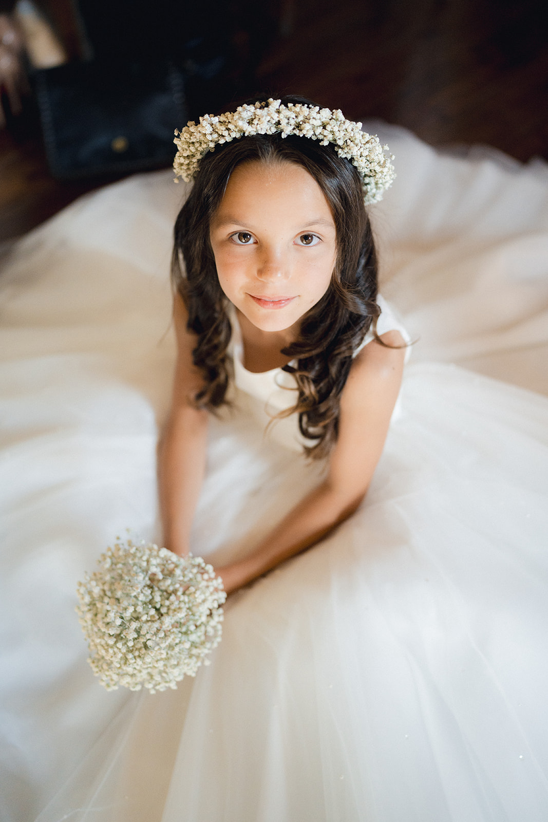 The flower crown on the dress of the little flower girl