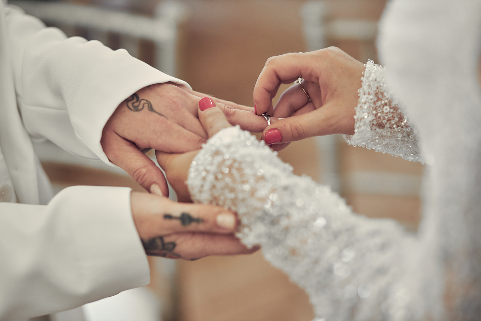 bride putting the wedding ring to her bride's finger