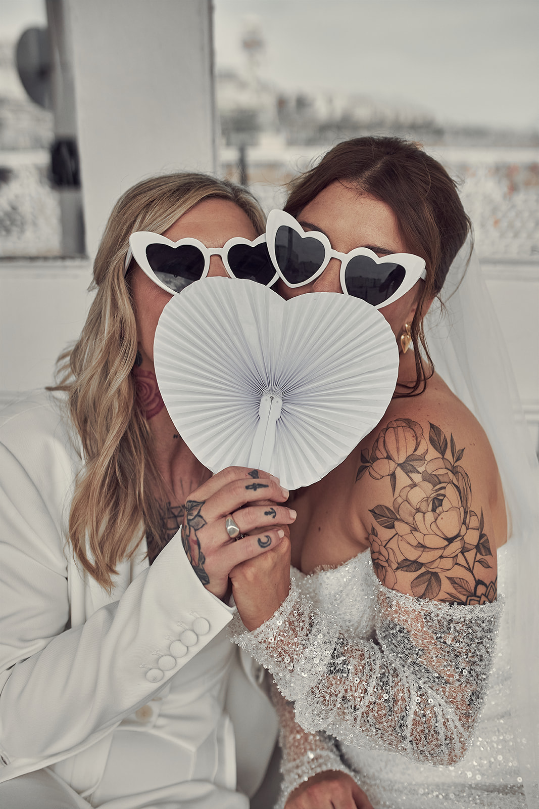 brides cover their faces with fan