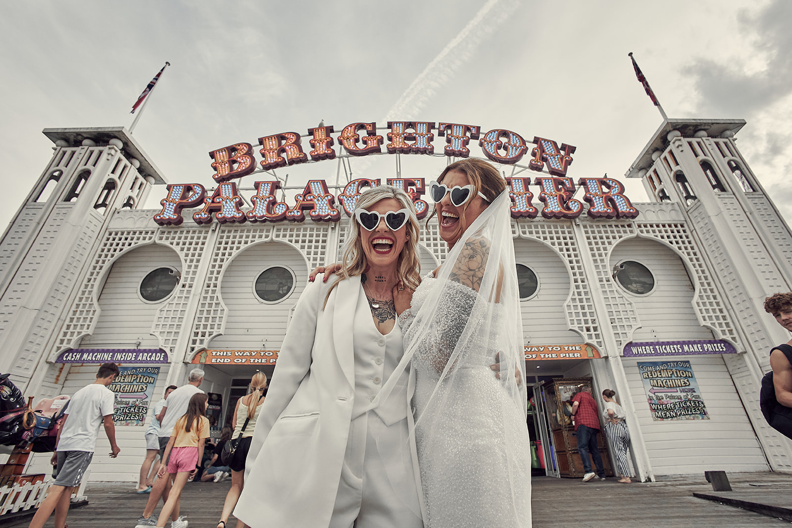 brides laughing hard in brighton palace pier