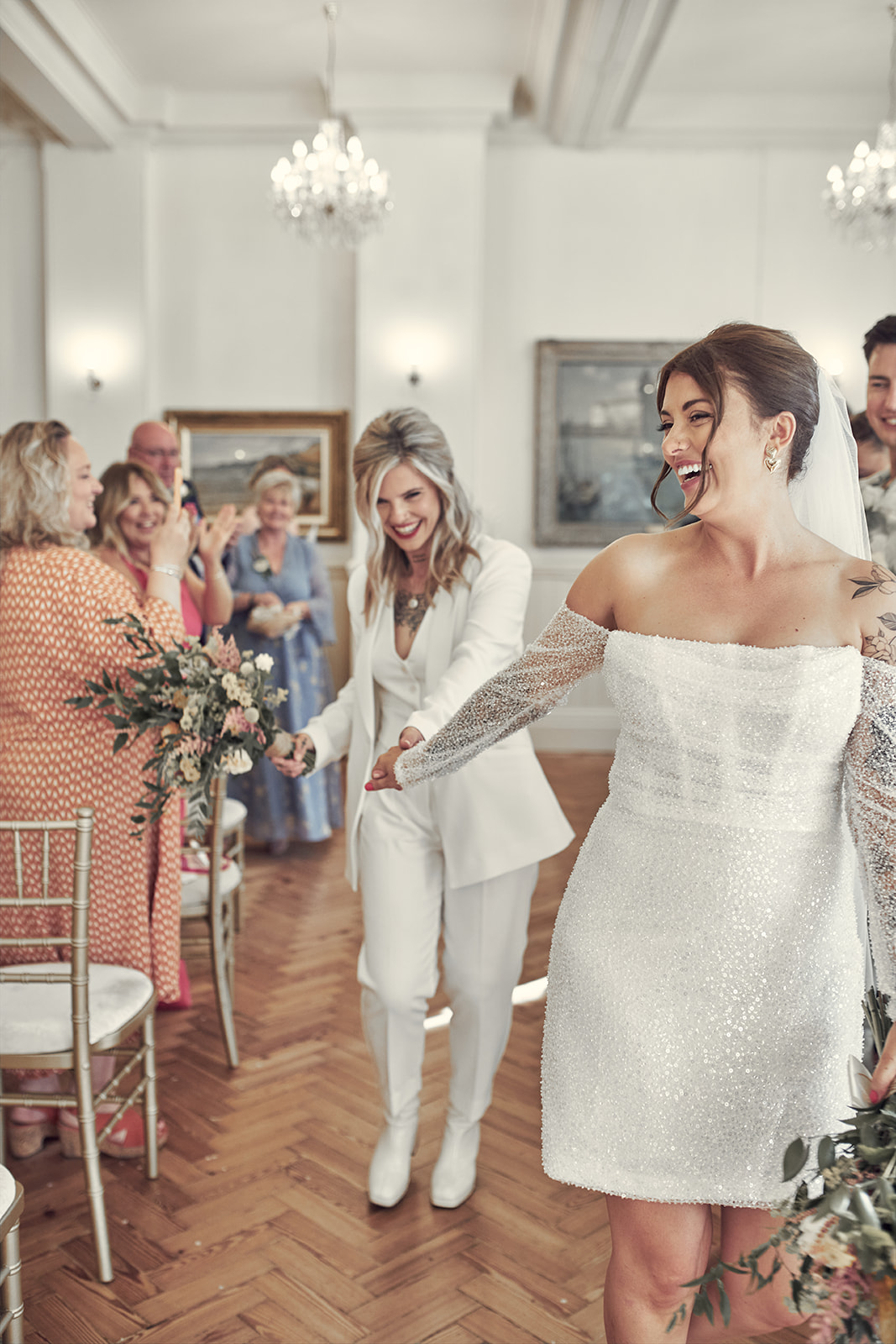 brides make their way out of the room