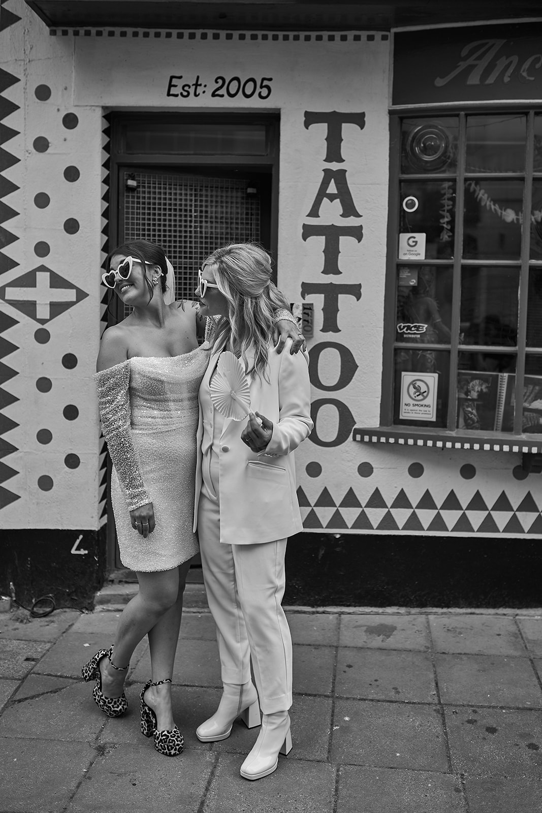 brides poses outside a tattoo shop