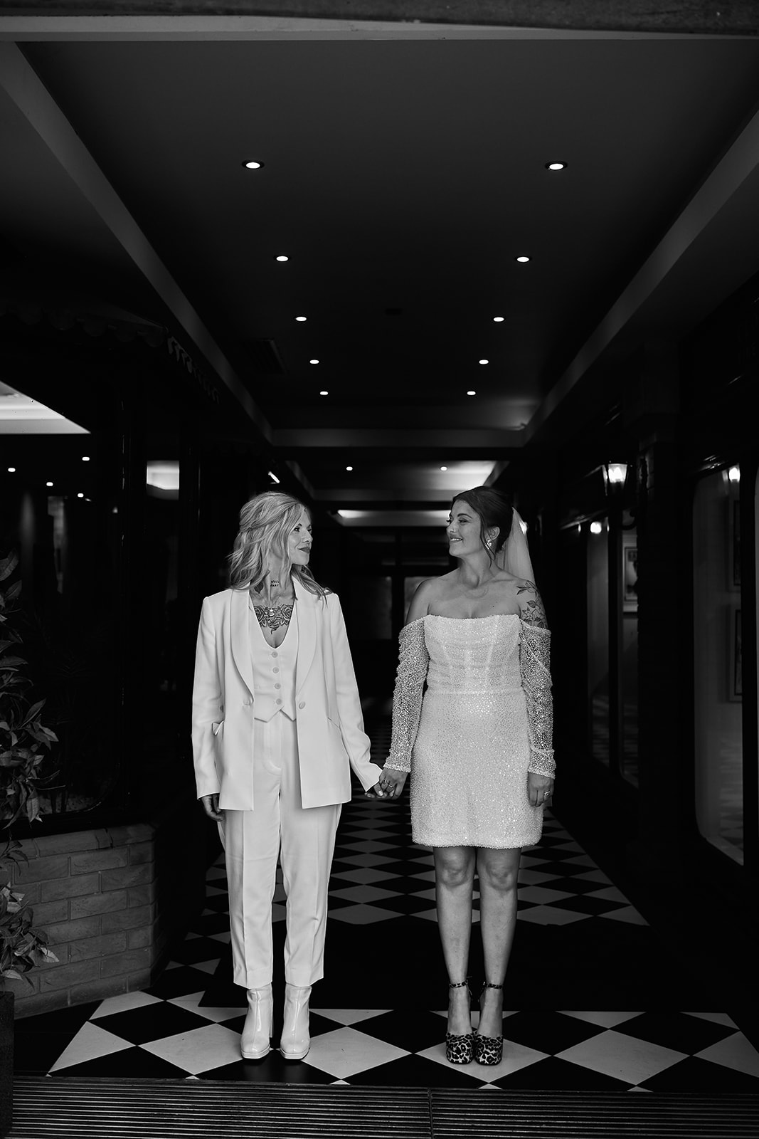 brides standing next to each other while holding hands