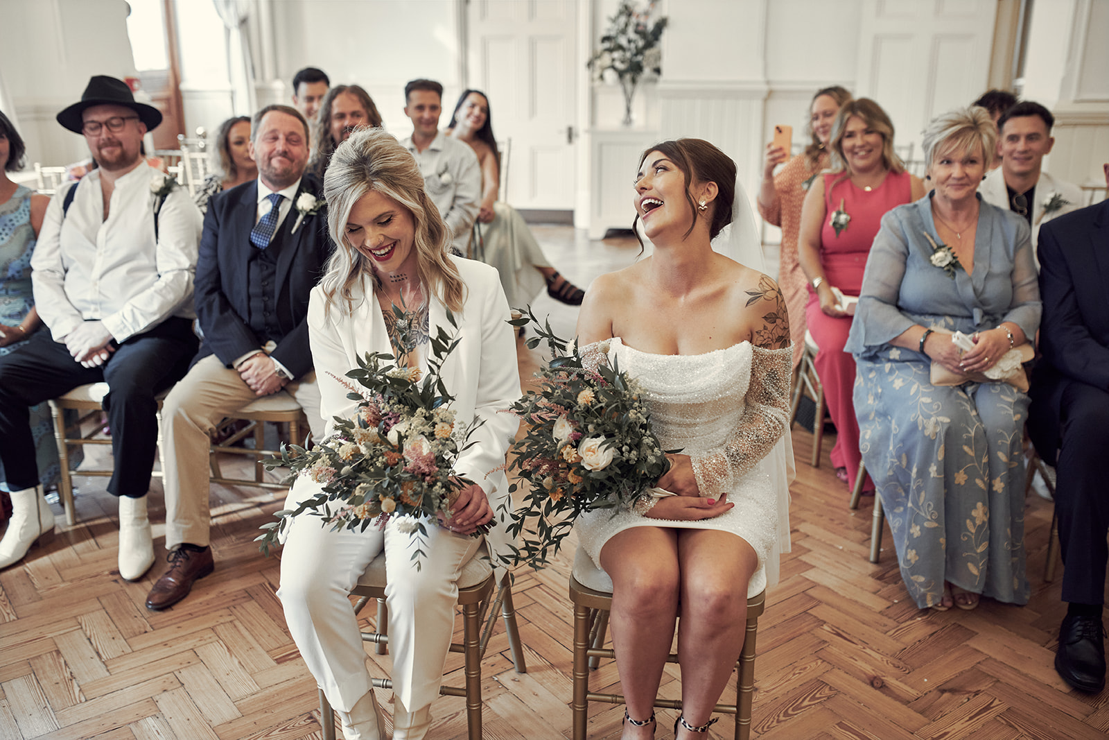 two brides sitting and laughing
