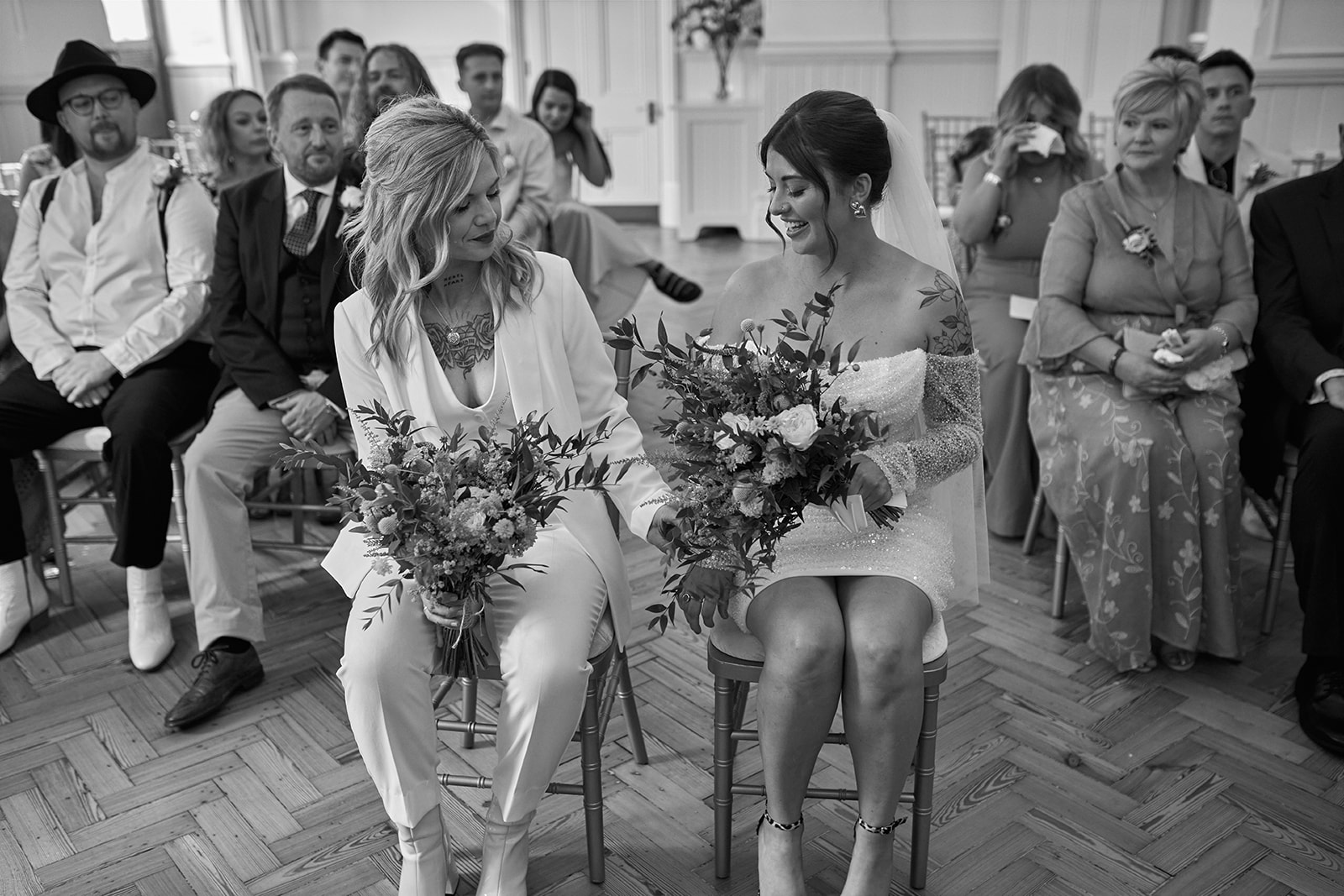 two brides sitting next to each other
