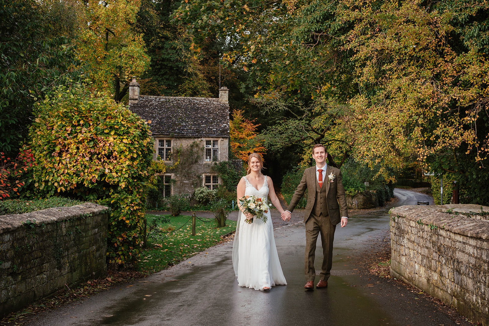 bride and groom walking across bridge Zara Davis Photography Wild Thyme and Honey Cirencester Cotswolds Gloucestershire