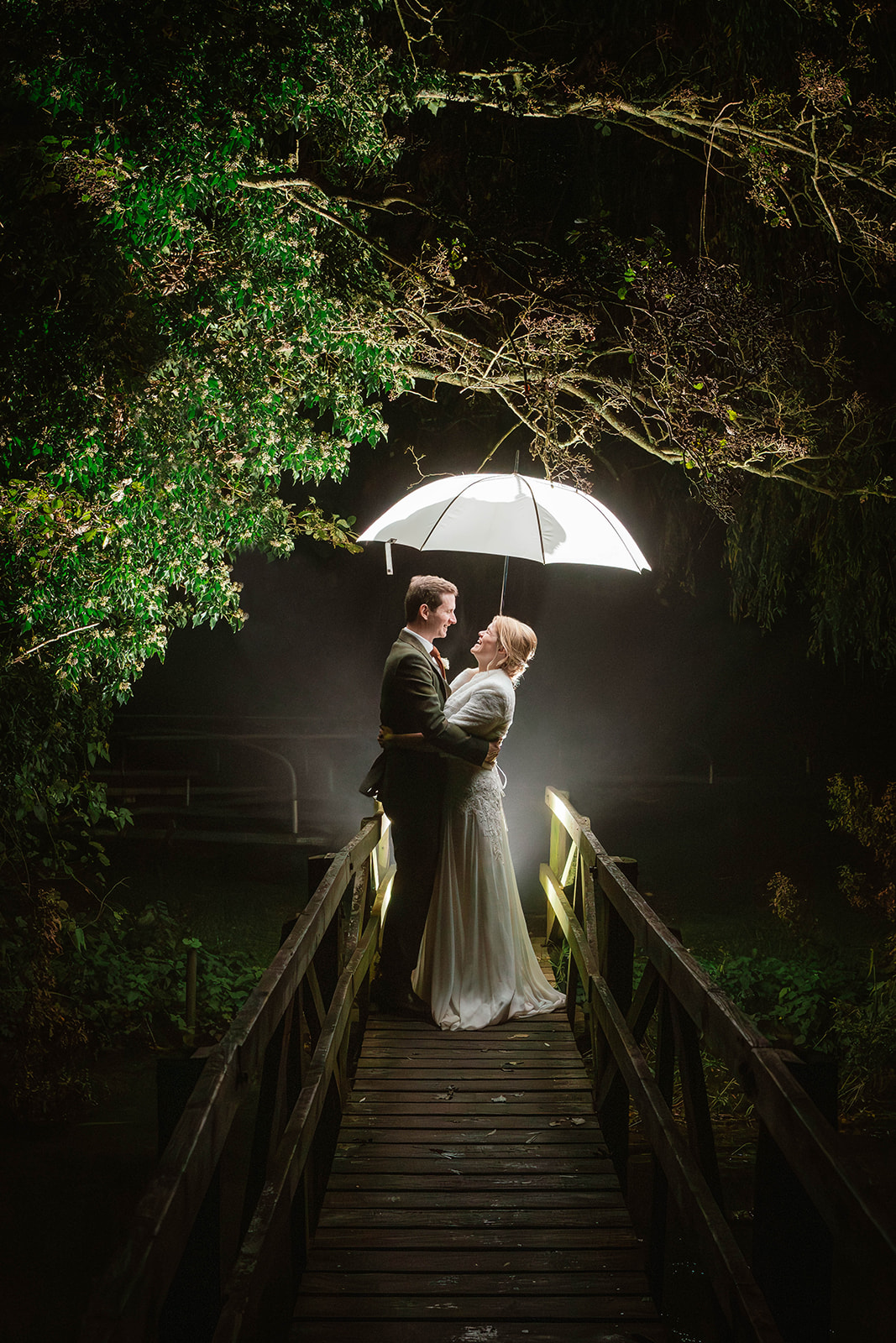 nighttime portrait of bride and groom on bridge Zara Davis Photography Wild Thyme and Honey Cirencester Cotswolds Glouce