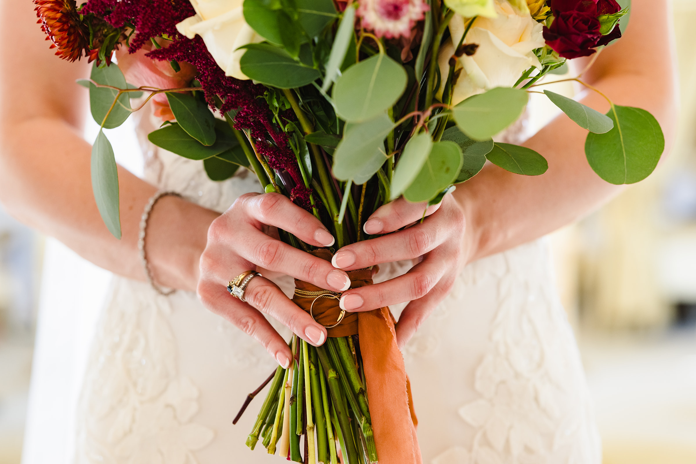bridal bouquet with wedding rings attached