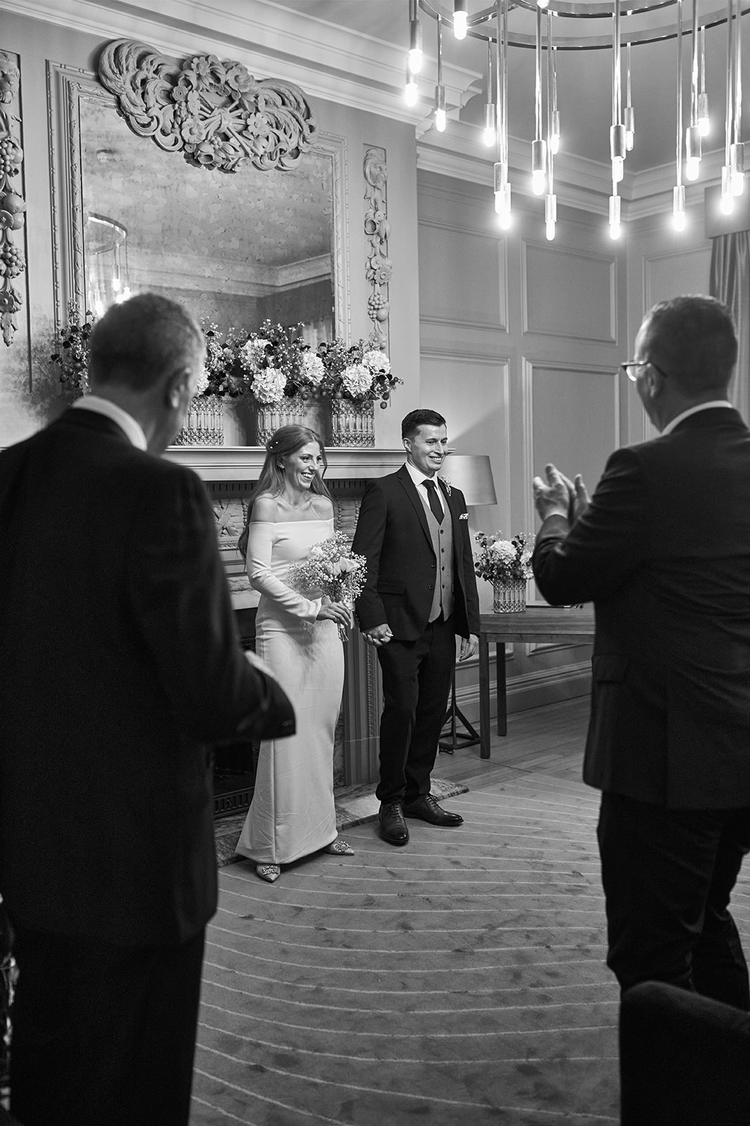 bride and groom applauded by guests