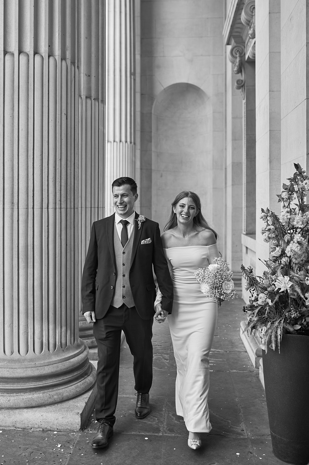 bride and groom laughing while walking