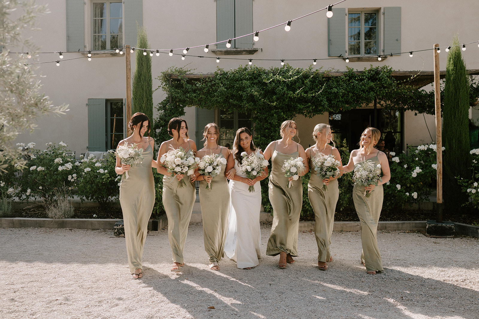 bridal party in neutral colour scheme walking at Le Mas Des Costes in provence