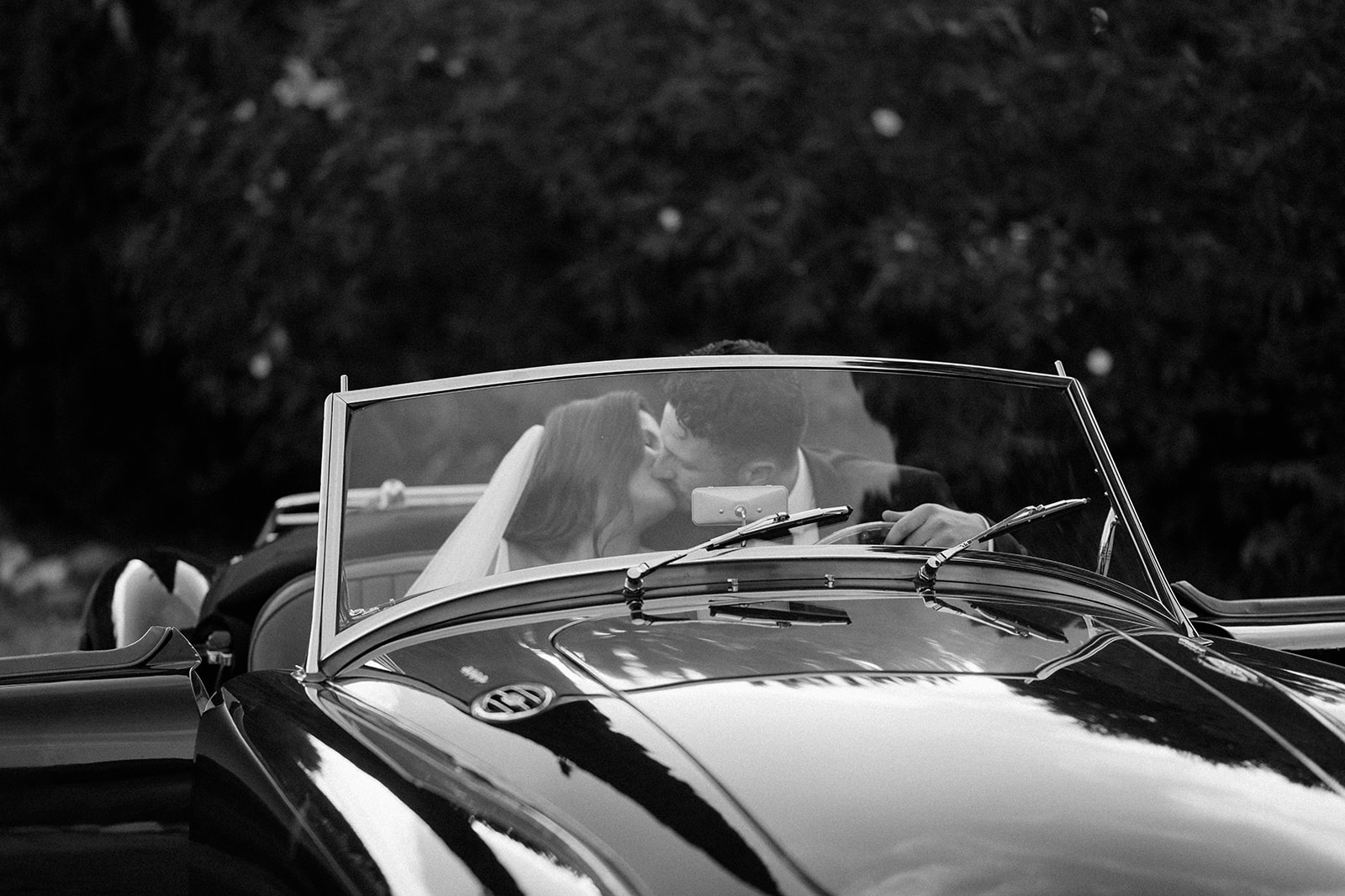 bride and groom sitting in vintage mg classic car in provence