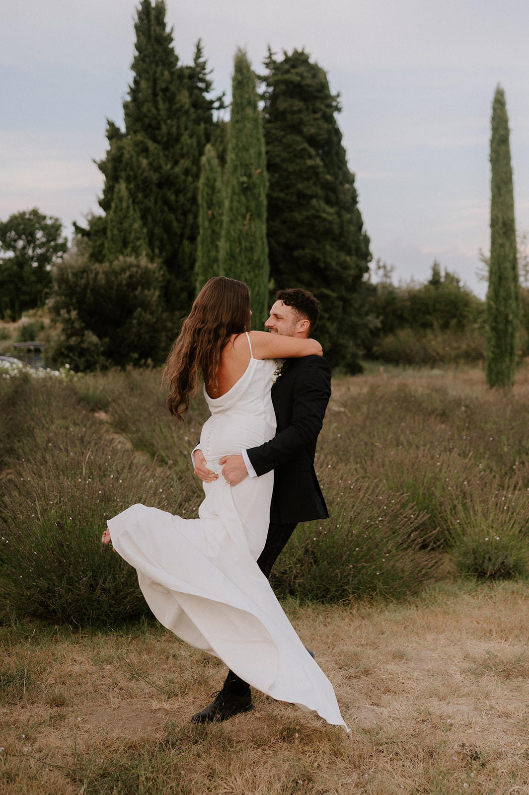 bride and groom spinning in field in provence