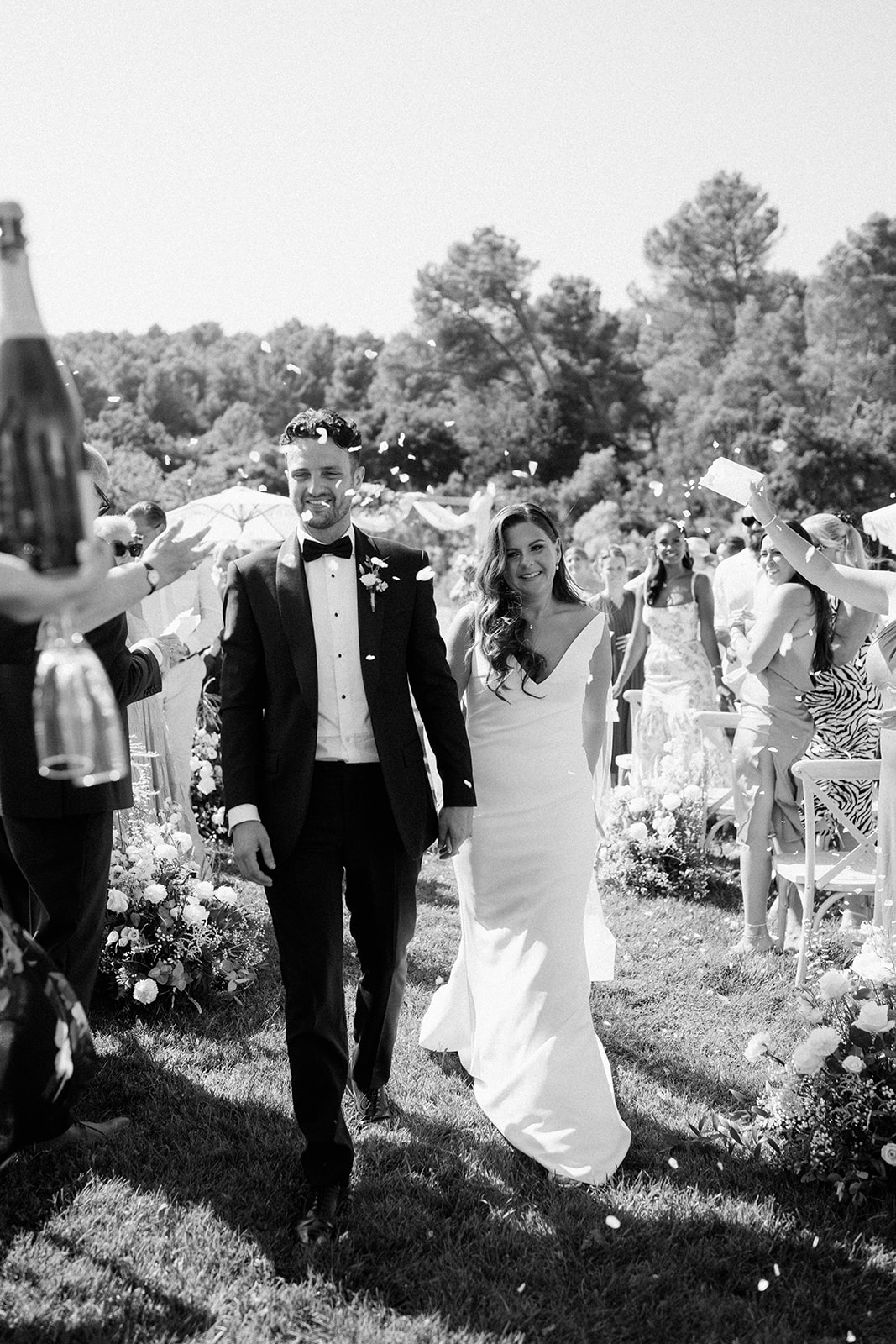couple walking through confetti line after getting married at Le Mas Des Costes