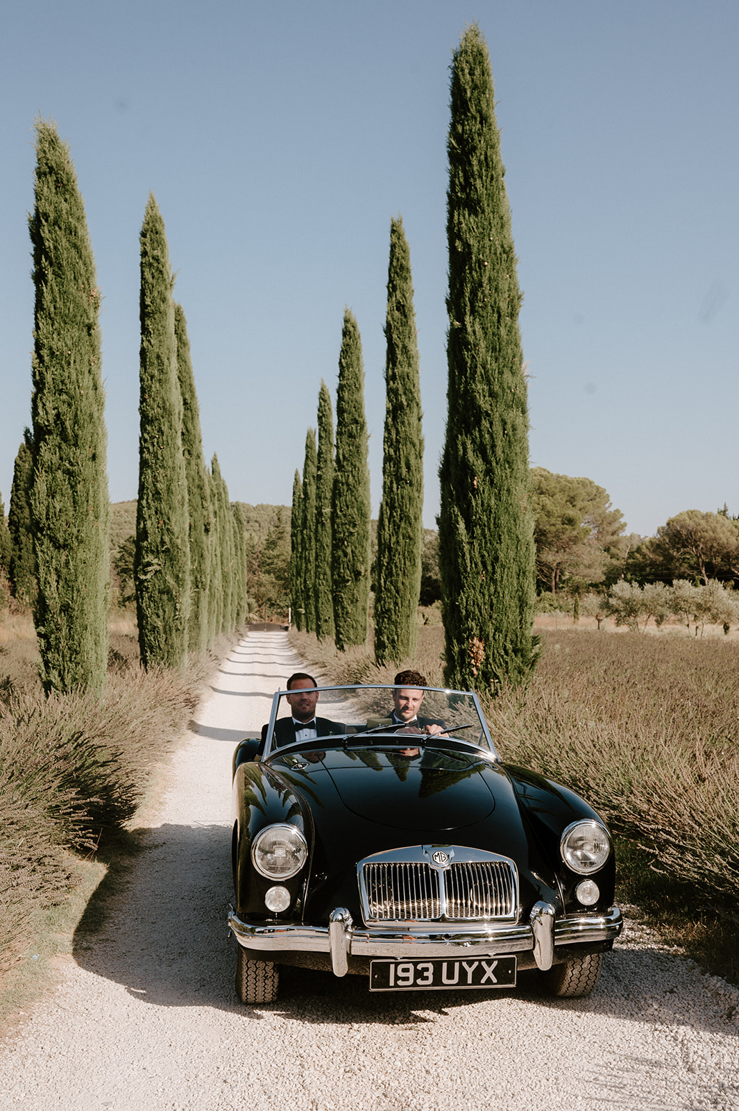 groom in vintage mg classic car at Le Mas Des Costes in provence