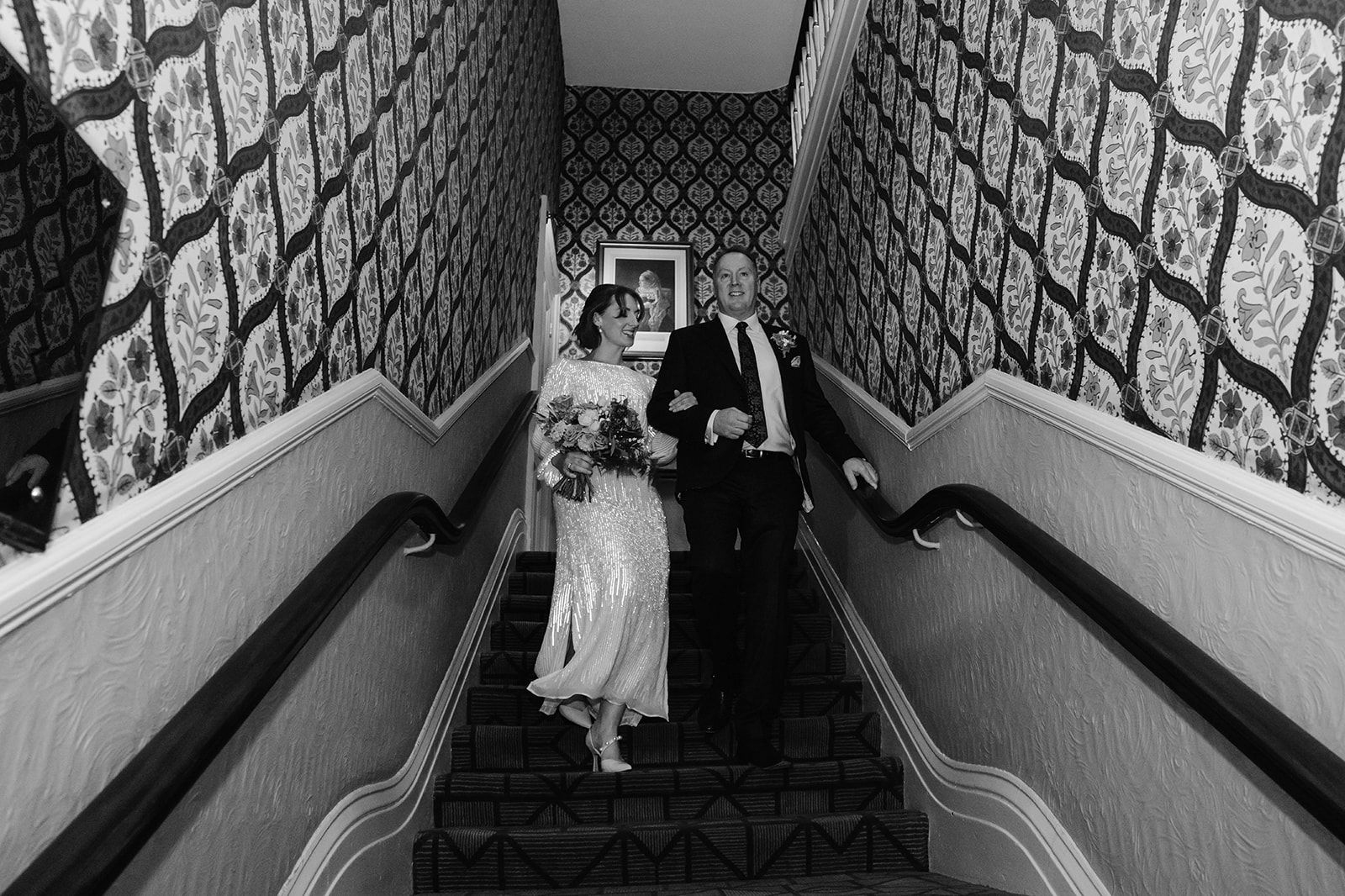 Zara Davis Wedding Photography Cotswolds Gloucestershire Cheltenham bride and her father walking down stairs
