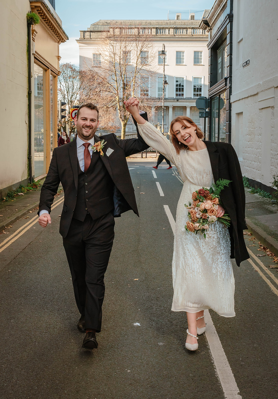 Zara Davis Wedding Photography Cotswolds Gloucestershire Cheltenham walking down the street bride and groom 
