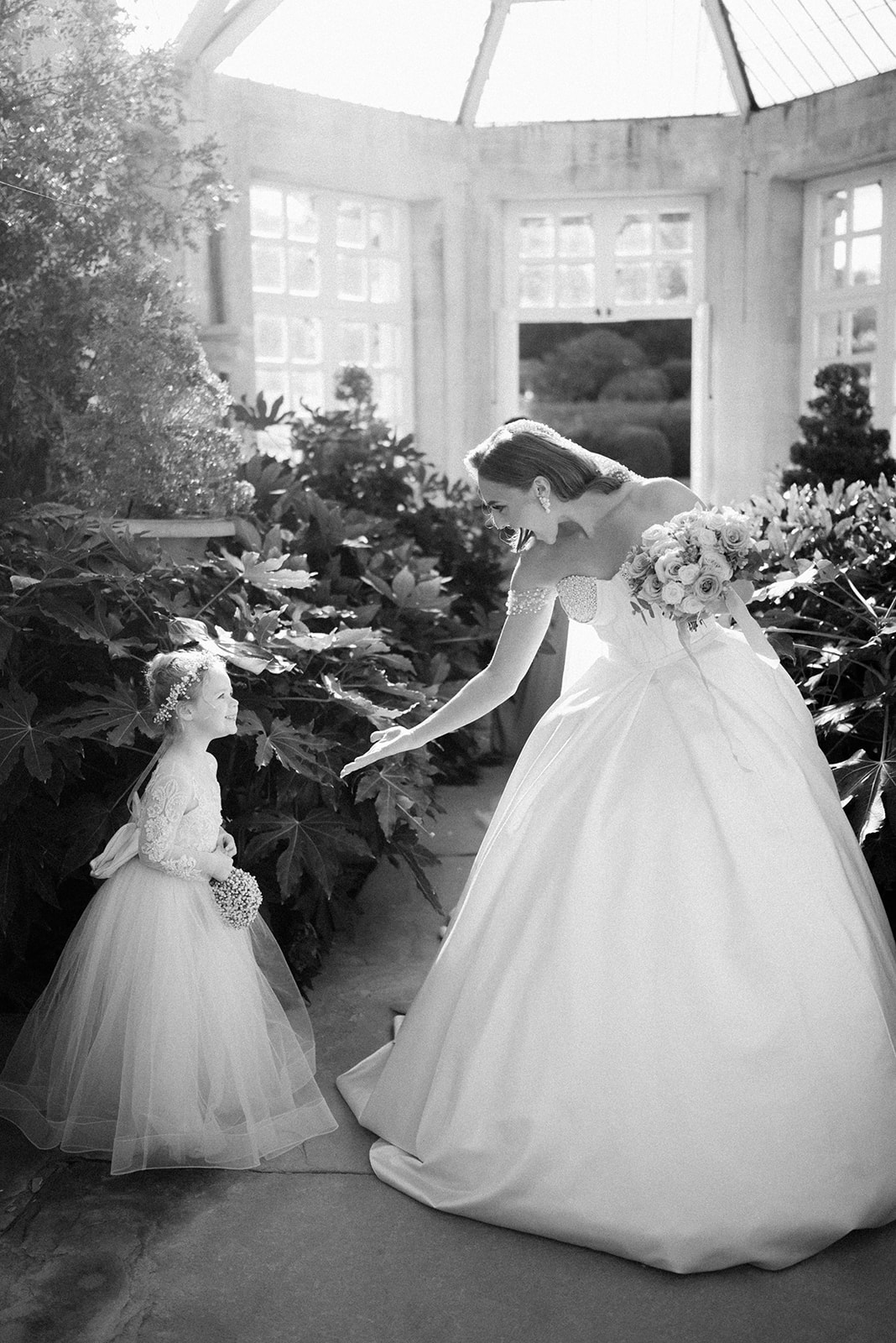 bride with flower girl in conservatory at harlaxton manor